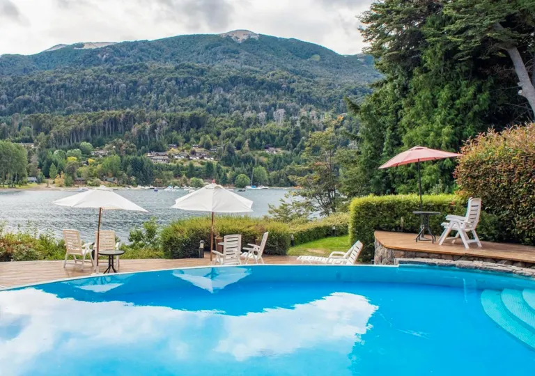 Outdoor pool with a large grassy hill in the background