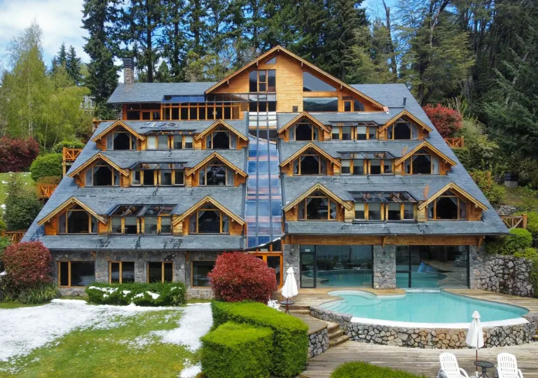 Exterior view of multi-story hotel building with a pool in front