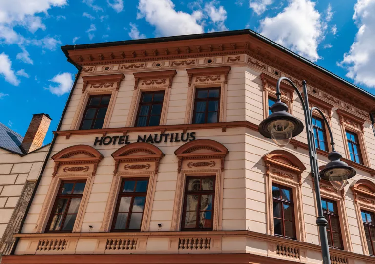 Exterior view of orange hotel building with the blue sky in the background