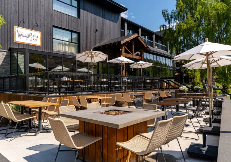 Outdoor patio with open fire pits and chairs around the area