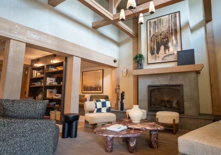 Hotel lobby lounge with cushioned chairs in front of a fireplace
