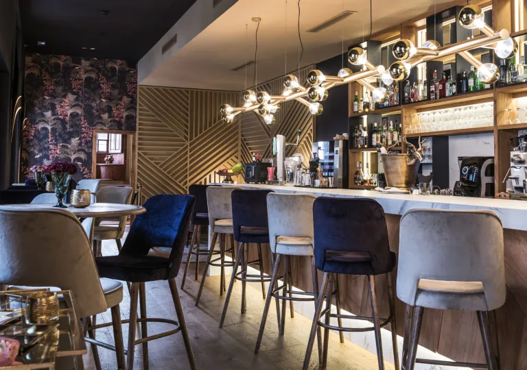 Bar with tall stools in front of  a bar counter