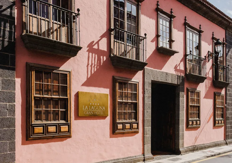 Exterior view of pink building with large windows