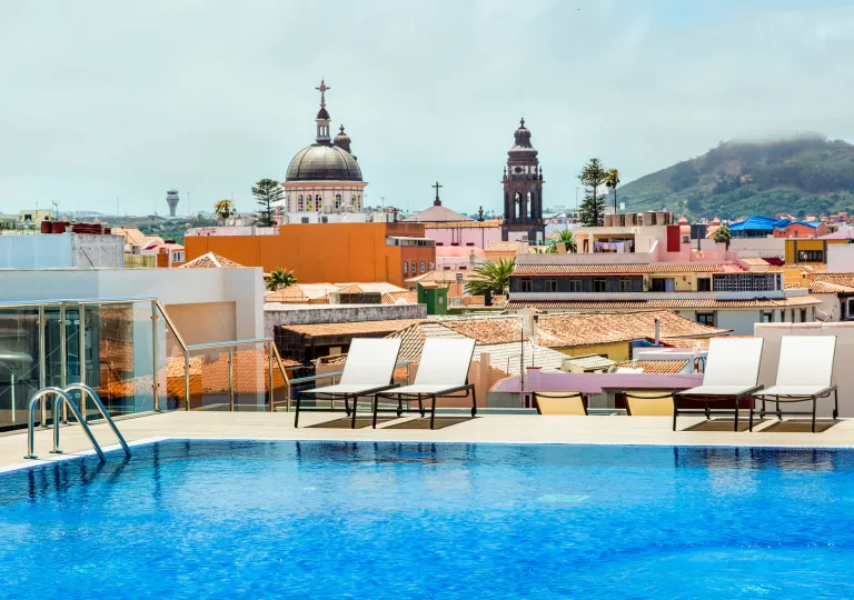 Outdoor, rooftop pool with a European town in the distance