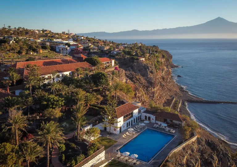 Exterior, sky view of buildings on a cliff with an outdoor pool