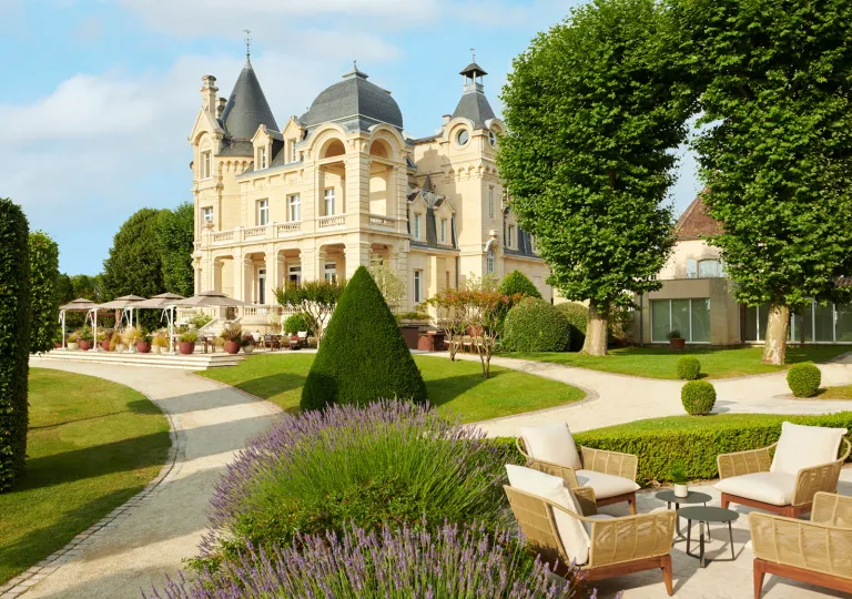 Garden with a large castle-like building in the background