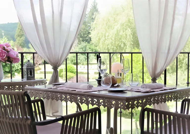 Outdoor patio with a dining table and gray steel chairs