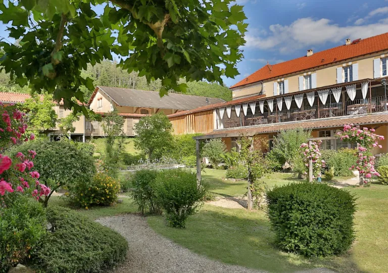 Exterior view of orange and yellow building with a garden in front