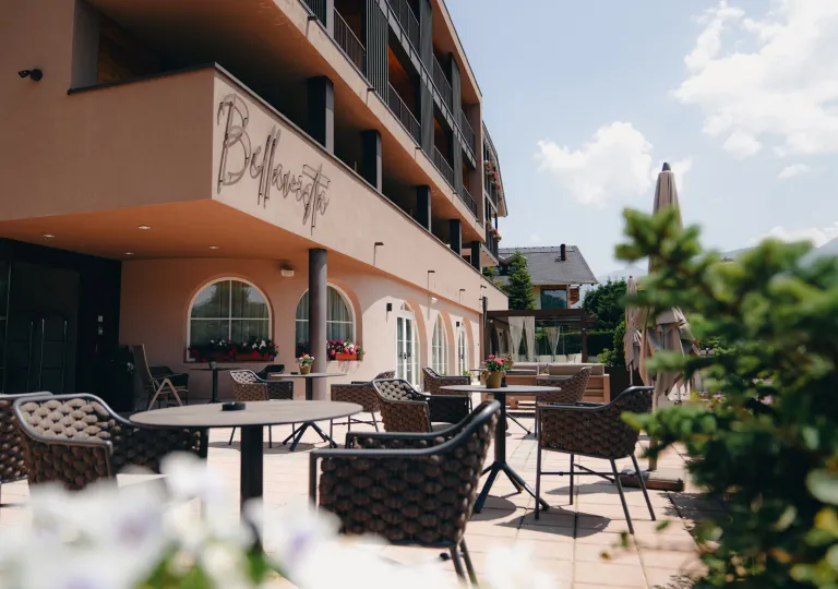 Outdoor patio next to a beige-colored hotel building