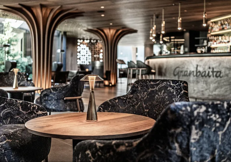 Hotel lobby with patterned, cushioned chairs and large pillars