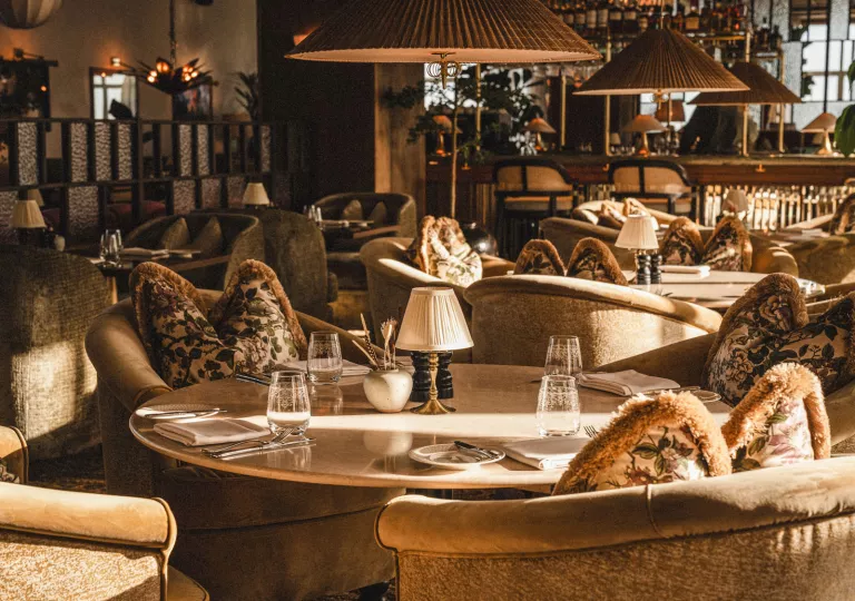 Indoor lounge with cushioned couches with circular tables