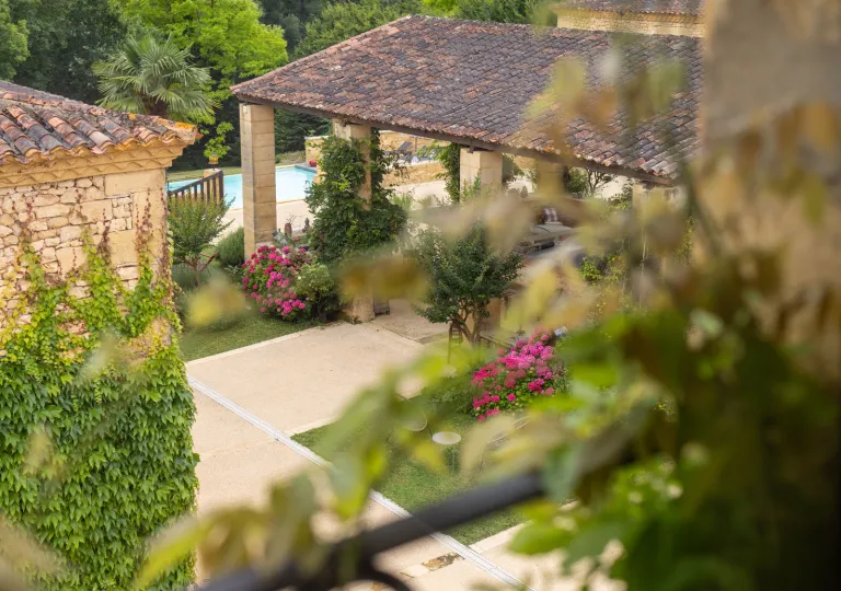 Sky view of stone building patio with a garden outside