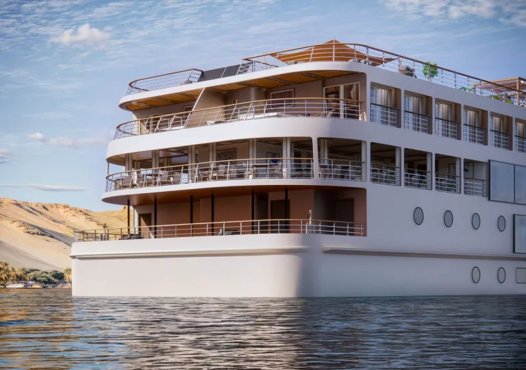 Close-up view of the stern of a luxury river cruise ship, showcasing spacious outdoor decks, private balconies, and open-air seating areas above calm river waters.