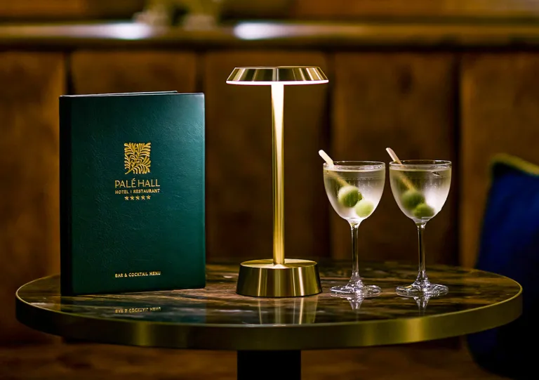 Circular, glass table with two glasses with alcholic drinks