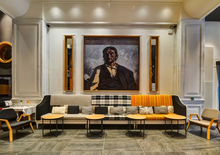 Long sofa in front of a large painting in a room