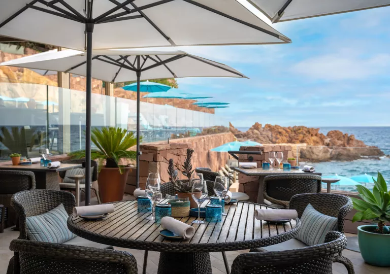 Outdoor patio with tables and views of the ocean