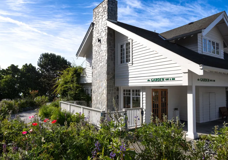 Sooke Harbour House hotel building exterior featuring a well-maintained garden lawn.