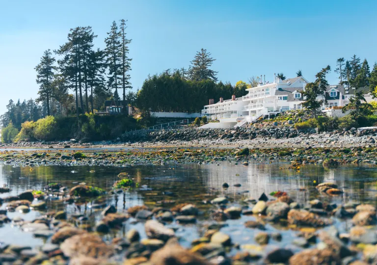 Exterior view of Sooke Harbour House, a hotel located on the coast of the Gulf Islands in British Columbia, Canada, featuring waterfront architecture.