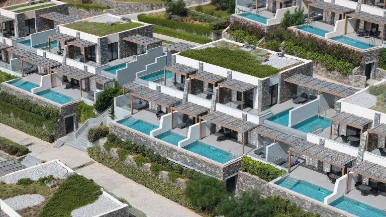Cayo resort arial view with blue pools and greenery.