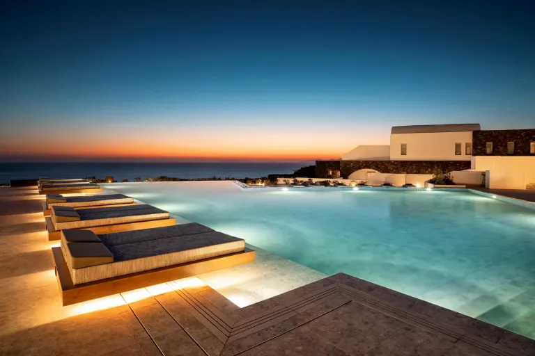 Infinity pool with loungers and the ocean on the horizon.
