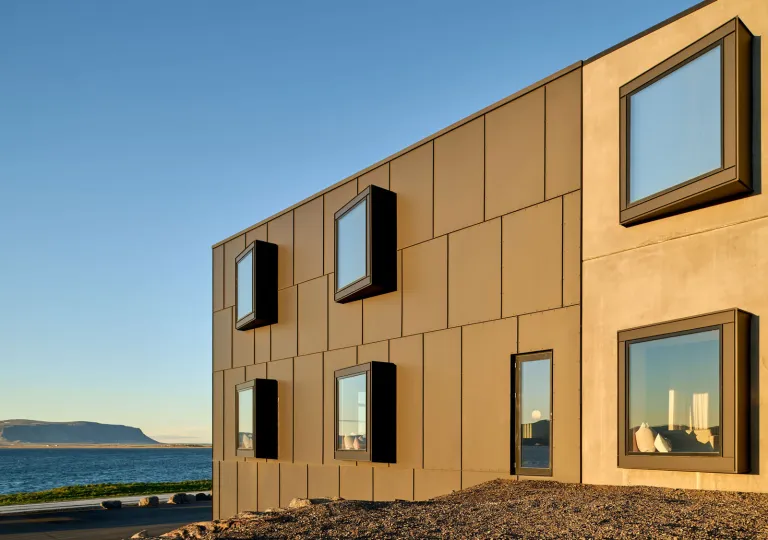 The neutral-toned modern exterior of the Black Sand Hotel located on the Ölfus peninsula along Iceland’s south coast.
