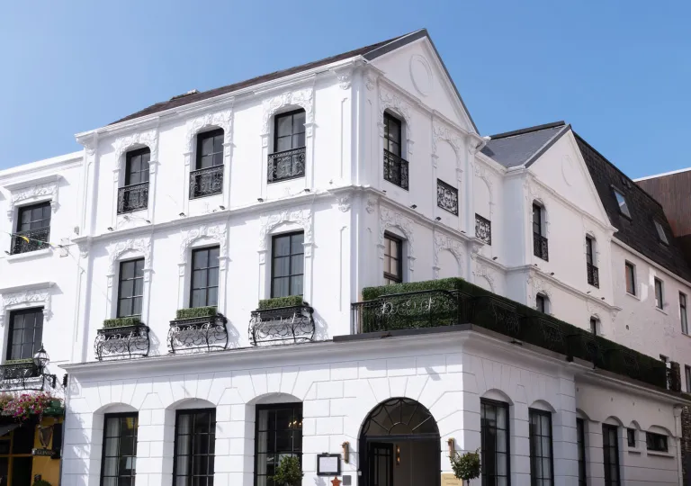 Exterior view of white and black building in the corner of a street