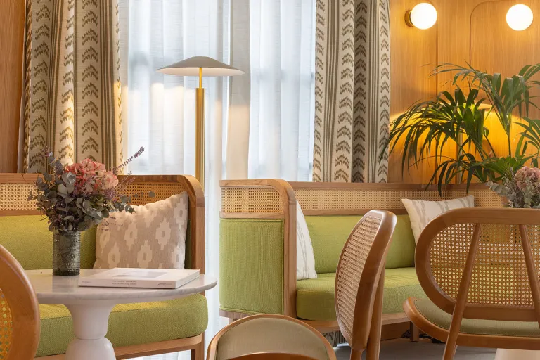 Lounge and seating area with green chairs and couches