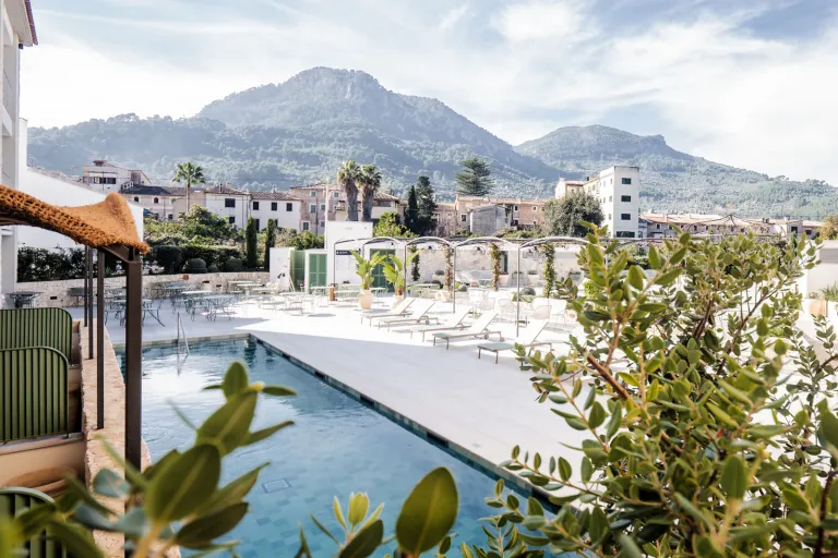 Outdoor pool with white buildings in the background