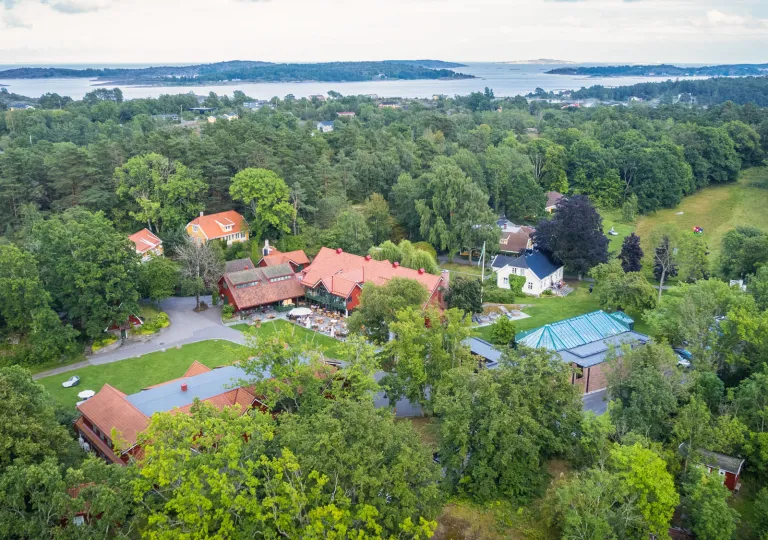 Sky view of a hotel complex in the middle of a large forest