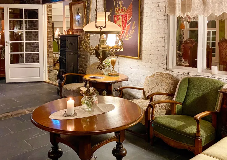 Lounge area with a circular, wooden table and cushioned chairs