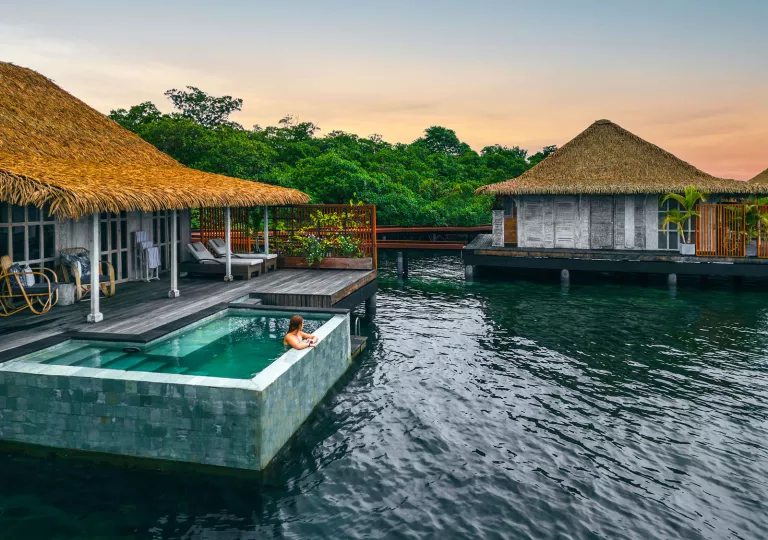 Exterior view of hotel cottages with an outdoor pool