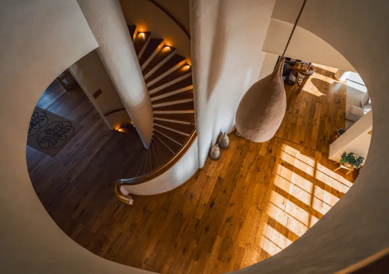 Top-down view of a staircase leading to a room with wooden floors