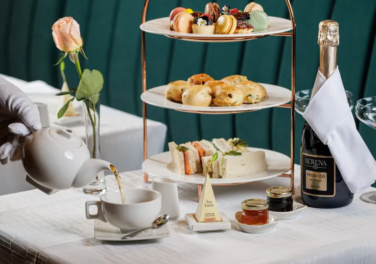White table with a tea set and thrree-tier plate holder