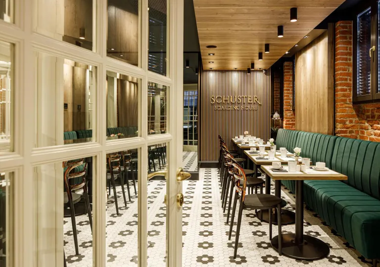 Restaurant dining area with checkered flooring and green booths