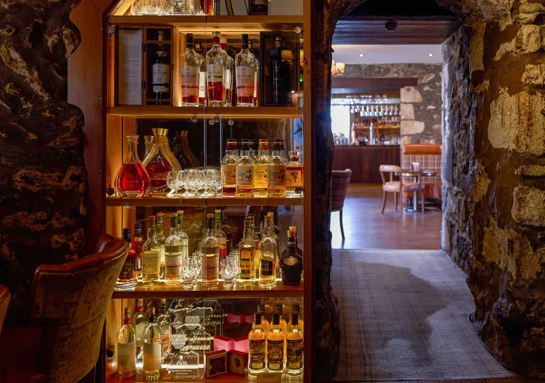 Underground cave with a shelve full of liquor bottles