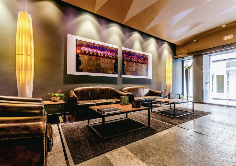 Leather sofas along a wall with stone flooring