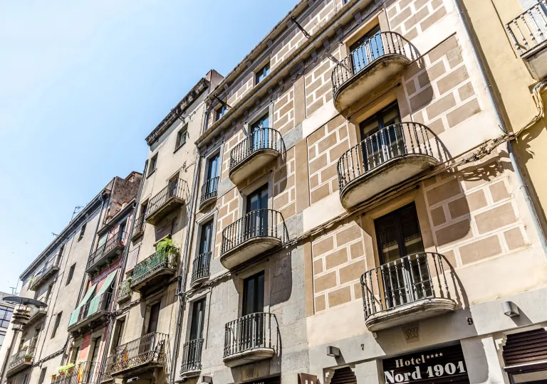 Exterior view of a multi-story, brick building with balconies