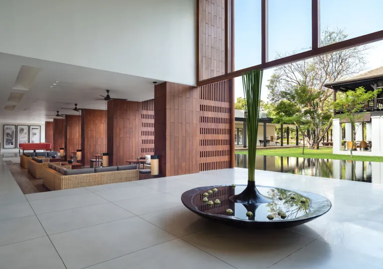Walkway in a building, with stone flooring and a large fountain