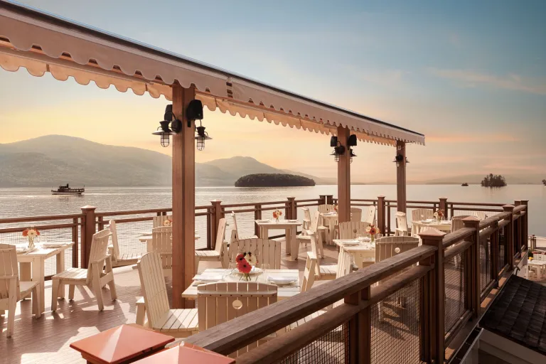 Outdoor patio and dining area with views of the ocean in the background