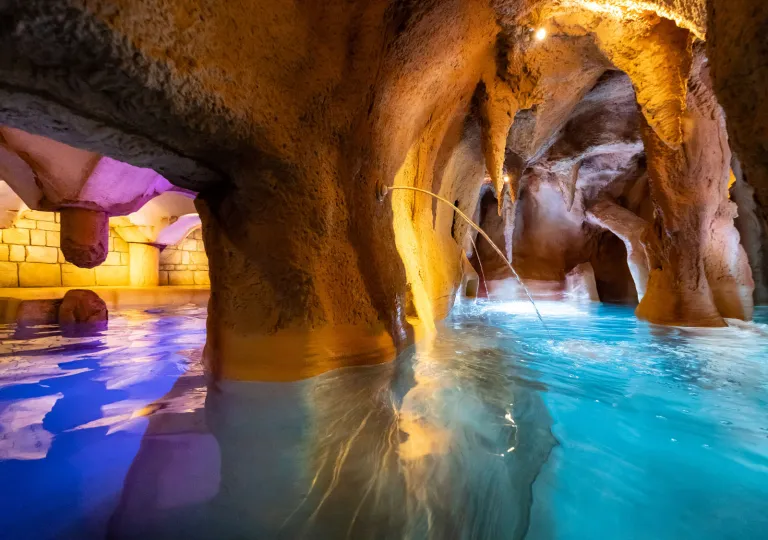 Underground cavern poo with blue and orange, illuminated lights