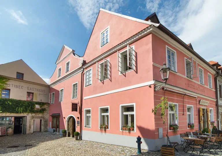 The pink exterior of Boutique Hotel Latrán in Český Krumlov, Czech Republic.
