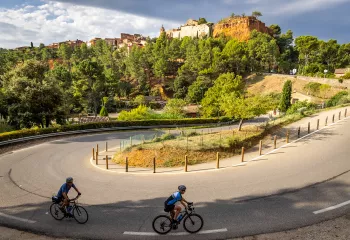 Guests cycling towards hilltop castle. 