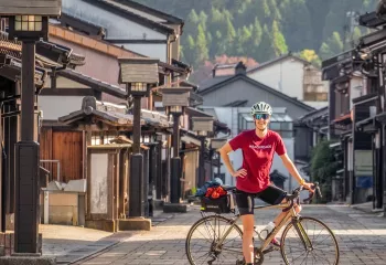Cyclist posing in a suburban street