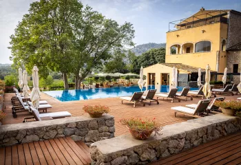 pool and lounge chairs outside of hotel