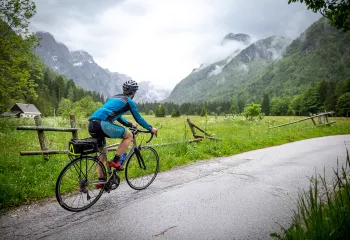 Woman biking looking at a grassy field
