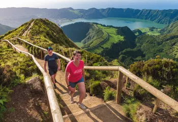 Man and woman walking up stairs on a path on a hill