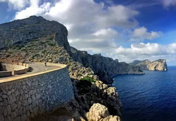 Windy road with a cliff and ocean in the background