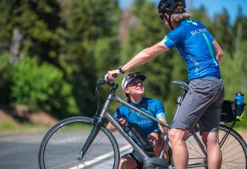 Woman checking on man's electric bike