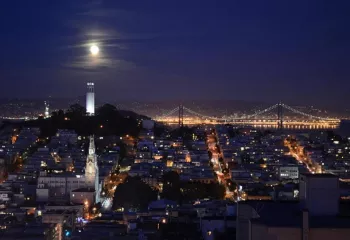 Evening, city view of San Francisco with houses illuminated by lights