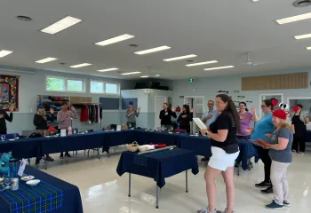 Group of people standing in a circle with their hands over their hearts